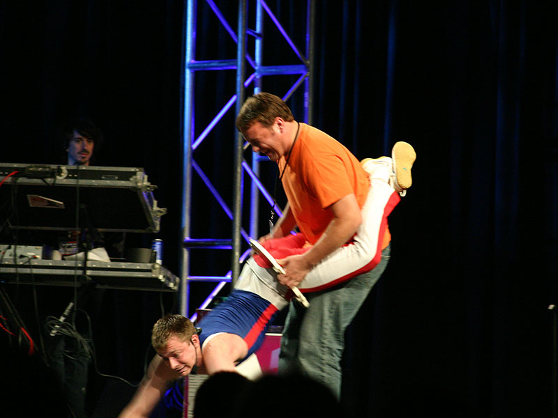 Why go to QuakeCon? So you can see a guy trying to pull another guy through a toilet seat, of course! Why go to QuakeCon? So you can see a guy trying to pull another guy through a toilet seat, of course!